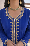 Close-up of the subtle vertical pinstripes and luminous blue fabric of the Azure kaftan.