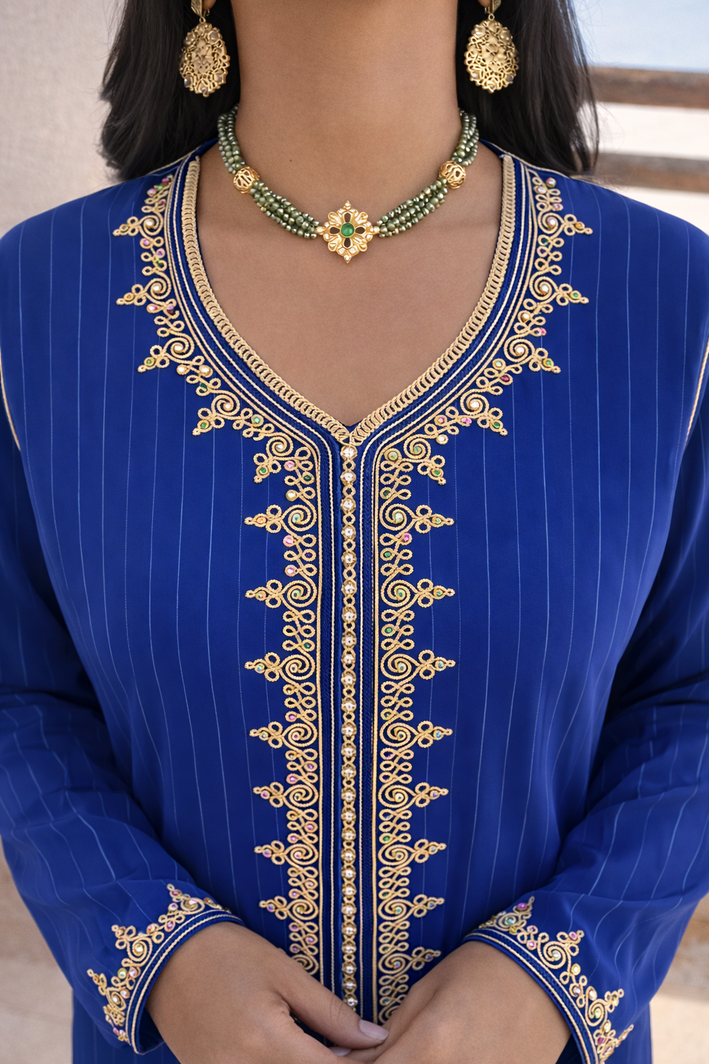 Close-up of the subtle vertical pinstripes and luminous blue fabric of the Azure kaftan.