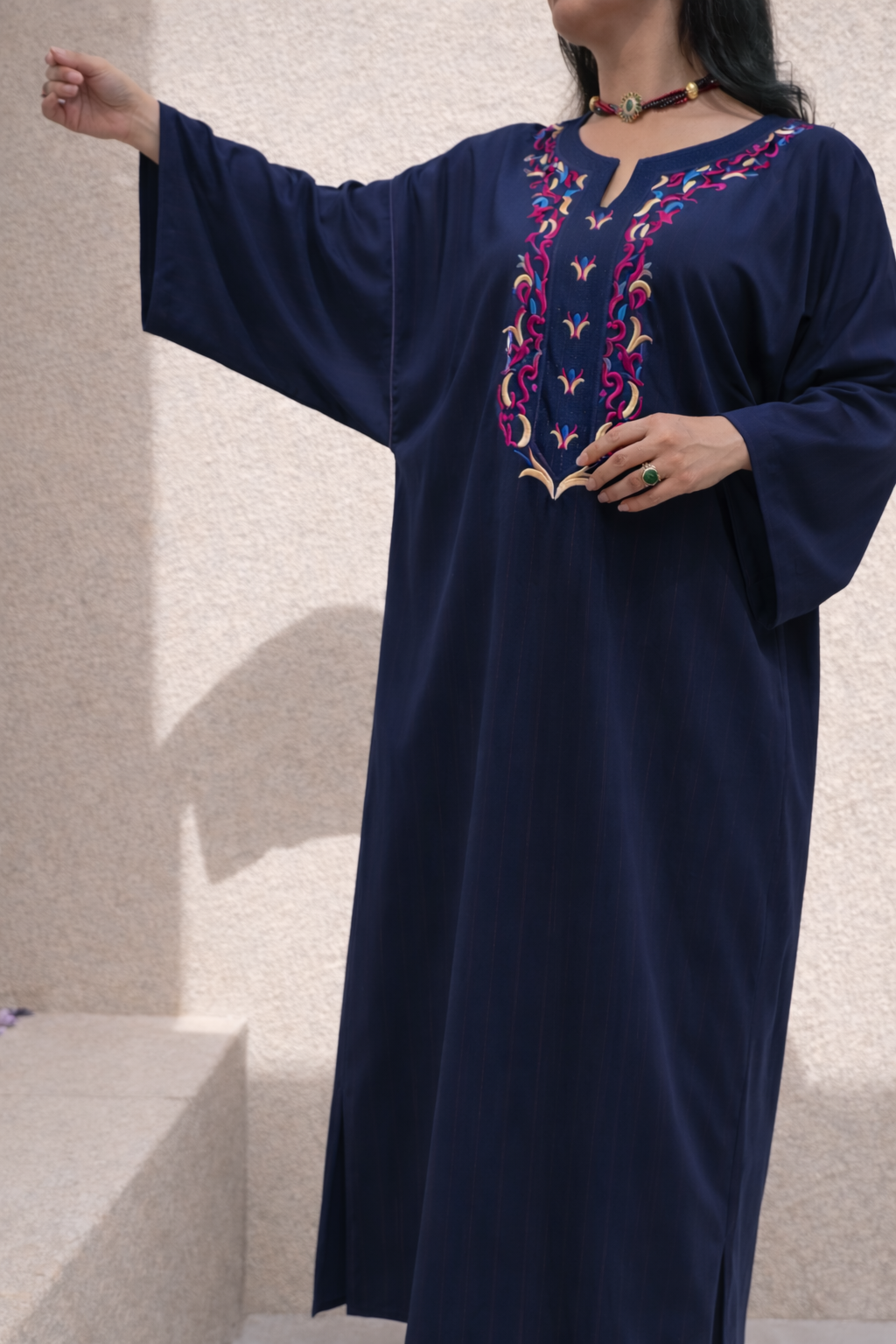 Full length view of the Maison Nelya Imperial Magenta Kaftan in deep magenta with gold embroidery.