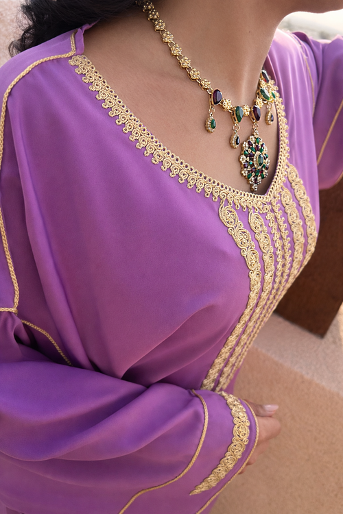 Detailed shot of the intricate gold thread work on the sleeve cuffs of the Maison Nelya emerald kaftan.