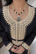 Close-up of the geometric gold motifs and traditional craftsmanship on the Midnight Heritage Kaftan.