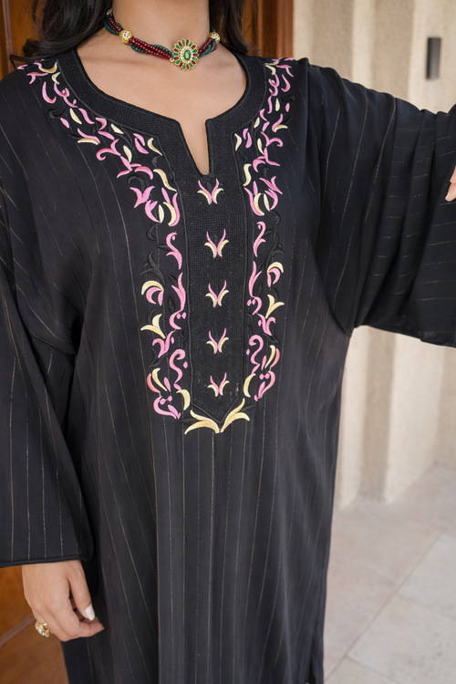 Full length view of the Maison Nelya Moonlit Noir Kaftan in deep black with majestic gold embroidery.
