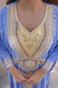 Close-up of the delicate gold embroidery cascading down the front of the powder blue kaftan.