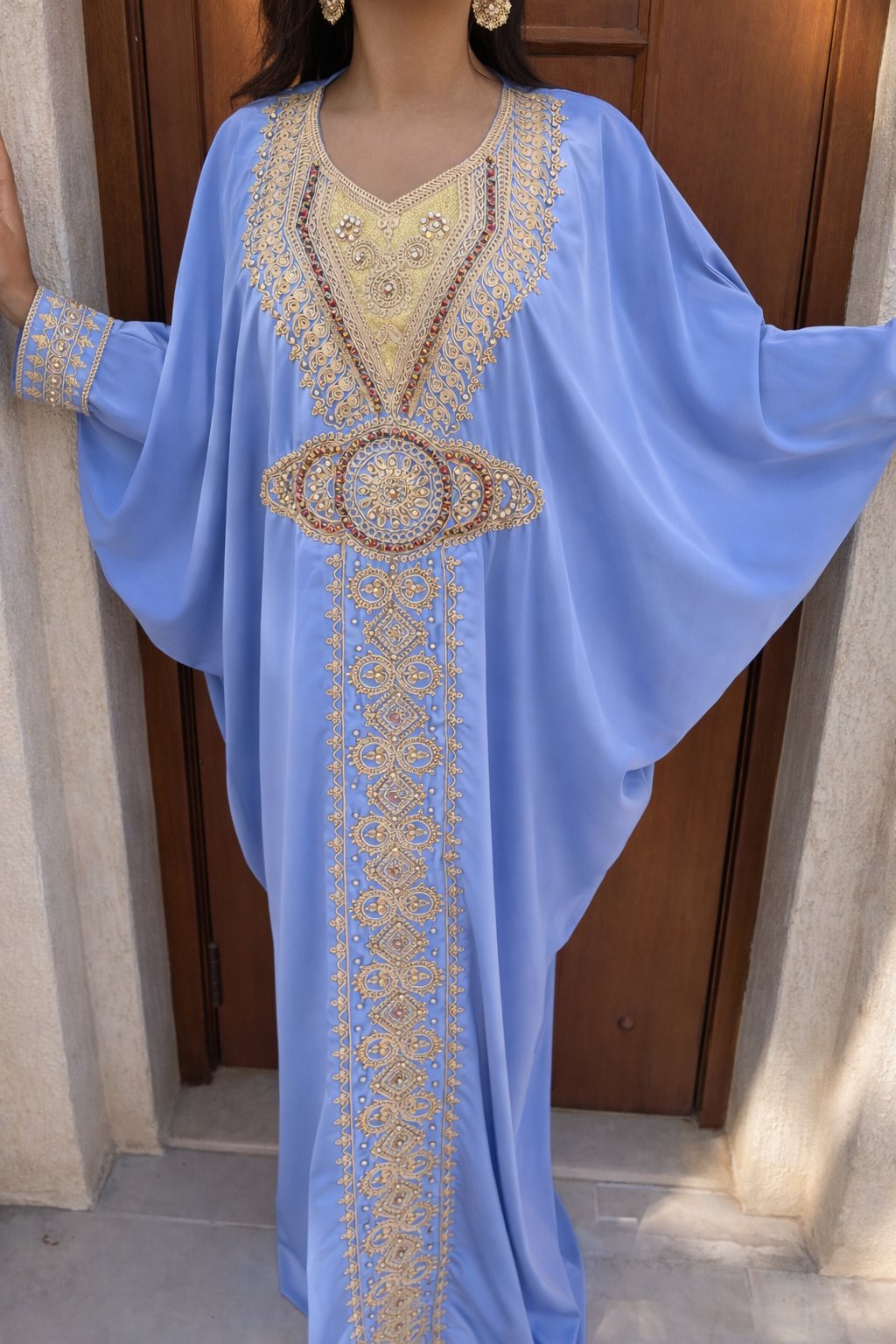 Full length view of the Maison Nelya Powder Blue Grace Kaftan in soft blue with gold embroidery.