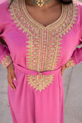 Detailed close-up of the handcrafted gold embroidery and crystals on the bodice of the rose pink Maison Nelya kaftan.
