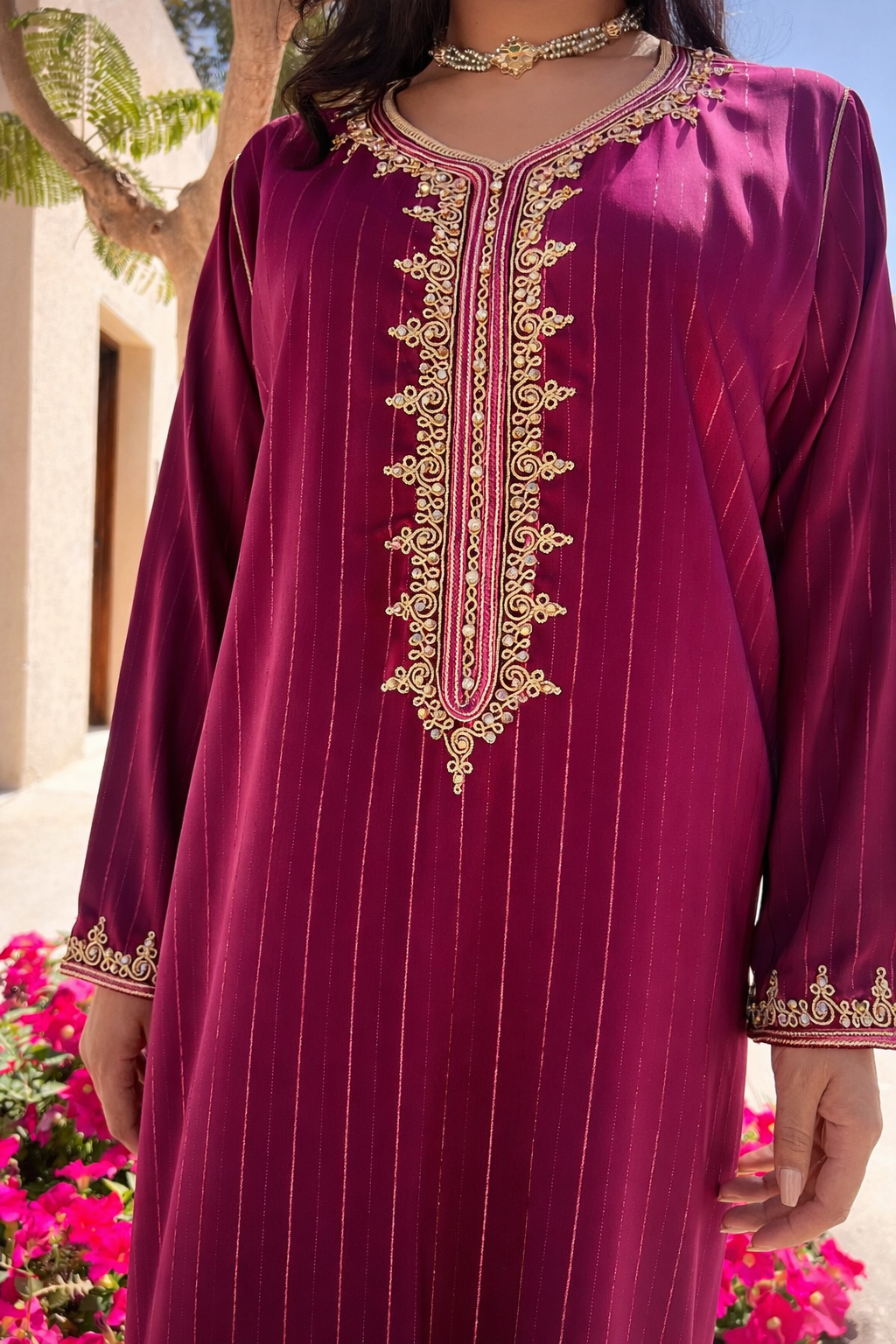Full view of the Maison Nelya Velvet Amaranth Kaftan in a rich reddish-purple hue with gold embroidery.