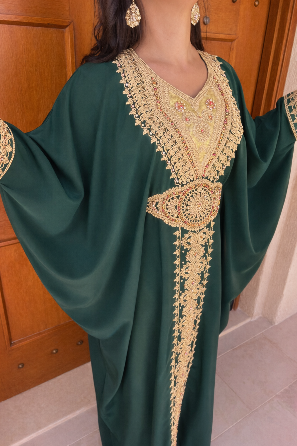 Full view of the Maison Nelya Verdant Grace Kaftan in deep emerald green with gold embroidery.